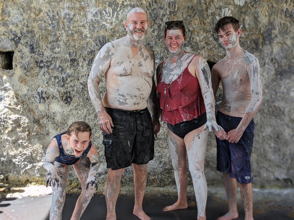 family in the mineral mudbath in St. Lucia