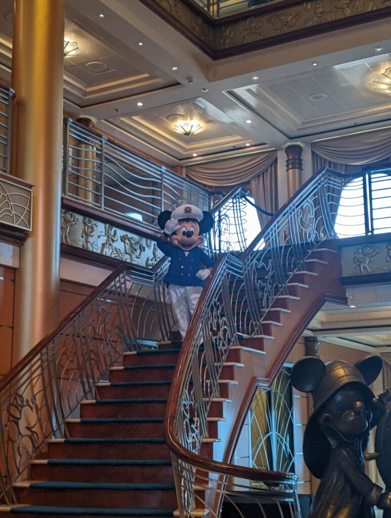 mickey mouse standing on stairs