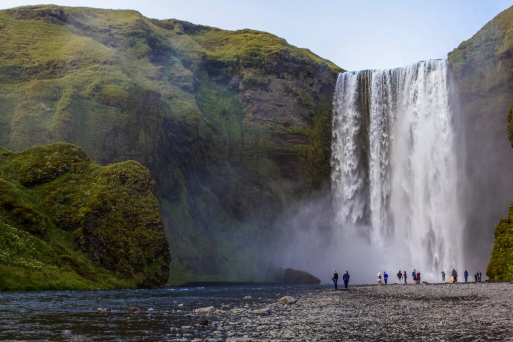 large waterfall amid green mountains